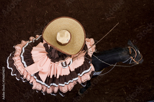 An escaramuza from Anahuac of Tecamac team rides her horse in a rodeo competition in Mexico City photo