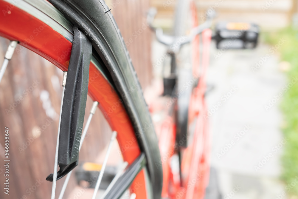 Repairing a punctured bicycle wheel. Special lever tool for removing the tire from the wheel. Repairing a punctured bicycle wheel. Special lever tool for removing the tire from the wheel.