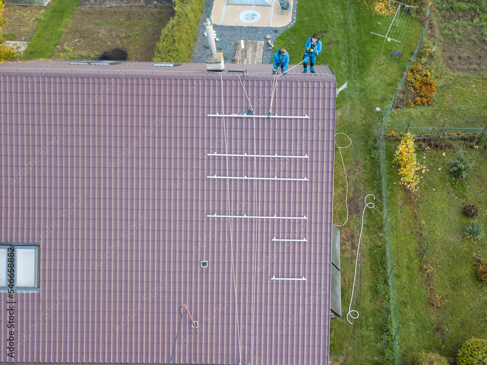Installation of photovoltaic panels. Aerial view of the construction of the photovoltaic power plant of the family house.