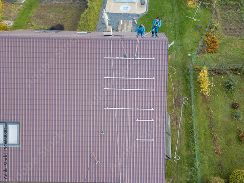 Obraz na płótnie Installation of photovoltaic panels. Aerial view of the construction of the photovoltaic power plant of the family house. w salonie