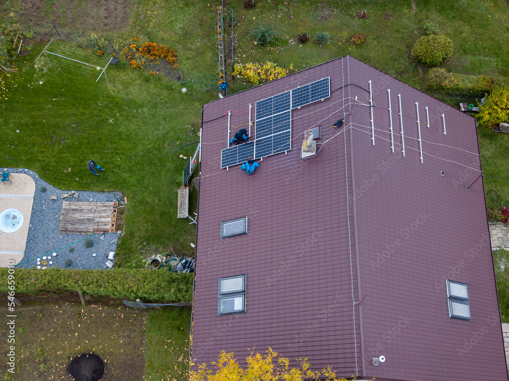 Installation of photovoltaic panels. Aerial view of the construction of the photovoltaic power plant of the family house.