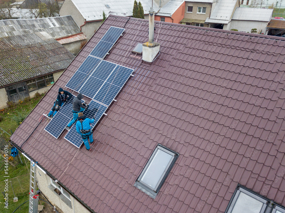 Installation of photovoltaic panels. Aerial view of the construction of the photovoltaic power plant of the family house.