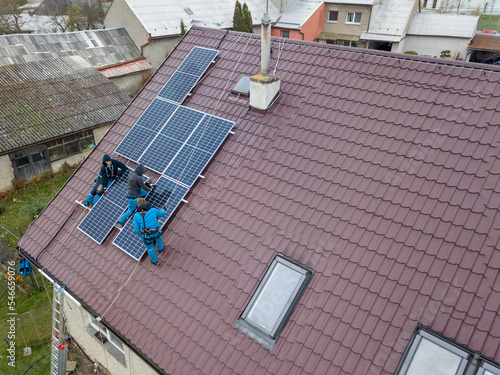 Obraz na płótnie Installation of photovoltaic panels. Aerial view of the construction of the photovoltaic power plant of the family house. w salonie