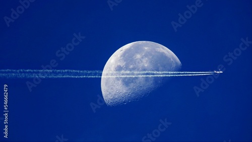Wallpaper Mural amazing aircraft plane jet trails contrails over the moon blue sky Torontodigital.ca