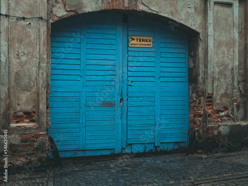 blue gate doors in ruined building