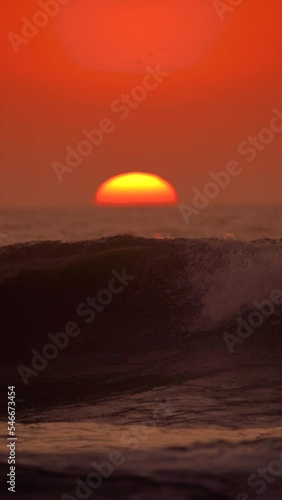 sunset over the sea with waves photo