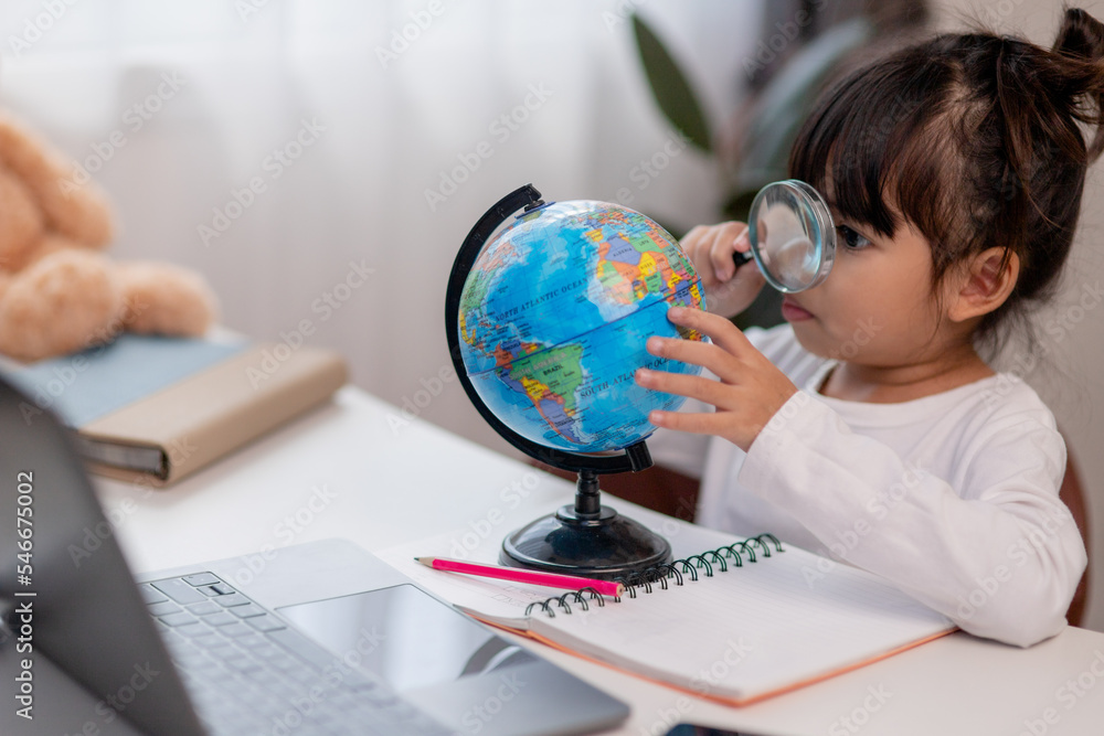 Asian little girl is learning the globe model, concept of save the world and learn through play activity for kid education at home. Asian little girl is learning the globe model, concept of save the world and learn through play activity for kid education at home.