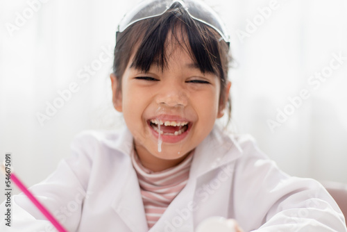 little Asian girl. child has a runny nose with clear snot,virus photo