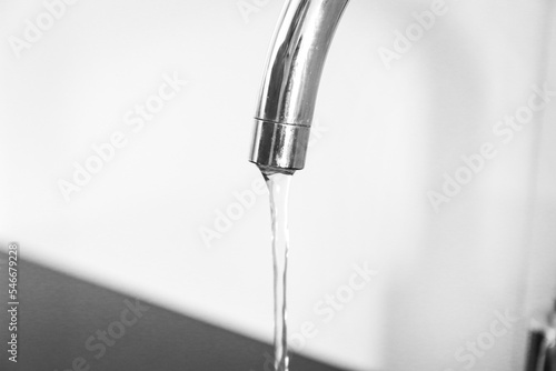 Getting water from the faucet in the kitchen. Water purification, dirty water, rise in price of water, lack of water
