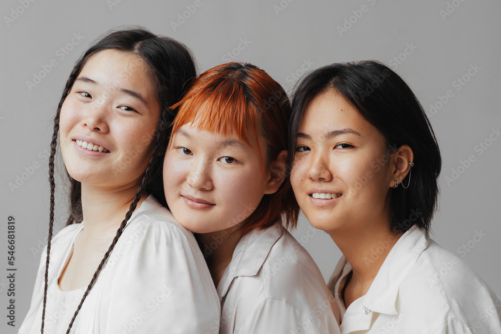Friendly Asian girlfriends smiling for camera