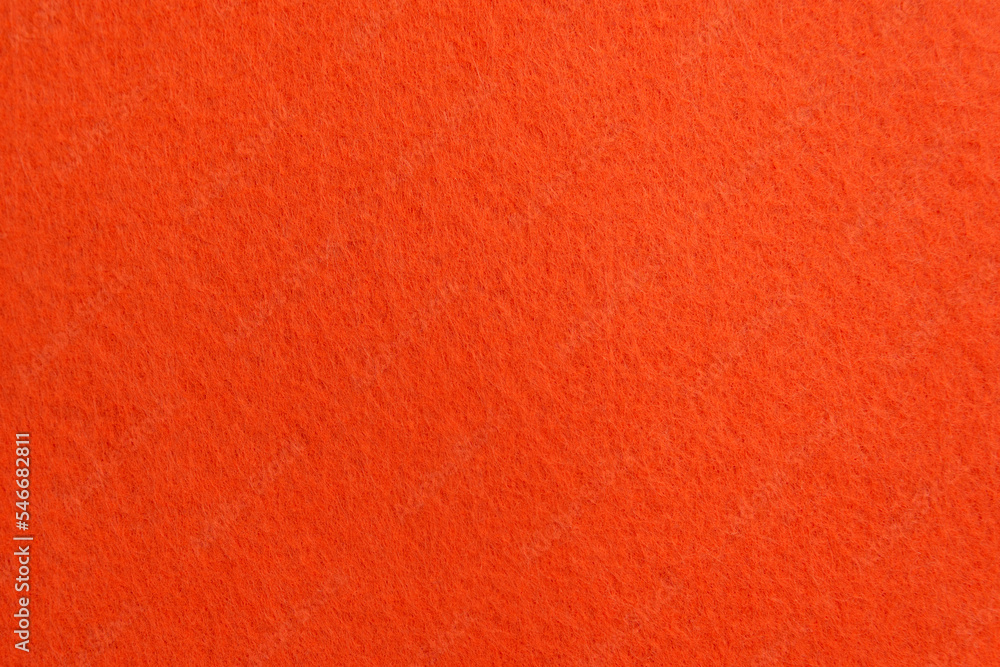 Fototapeta premium Orange texture velour or suede cloth close-up. Natural or artificial sewing material. Fabric as background for design.