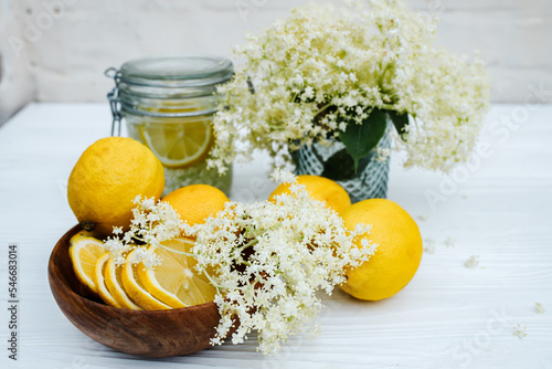 Ingredients for homemade lemonade from fresh syrup from elderberry flowers with lemons. Summer refreshing non-alcoholic cocktail photo