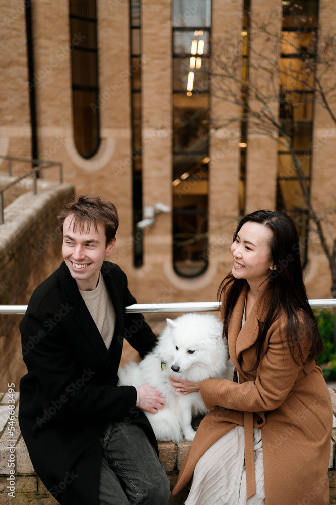 Couple walks outdoor with their dog Couple walks outdoor with their dog