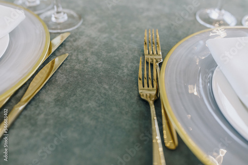 Golden cutlery on dining table  photo