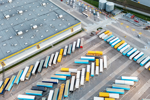 Many trucks and trailers are parked at the base, logistics and production center.