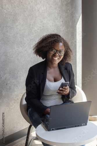 entrepreneur, smiling business woman portrait in cafe with laptop