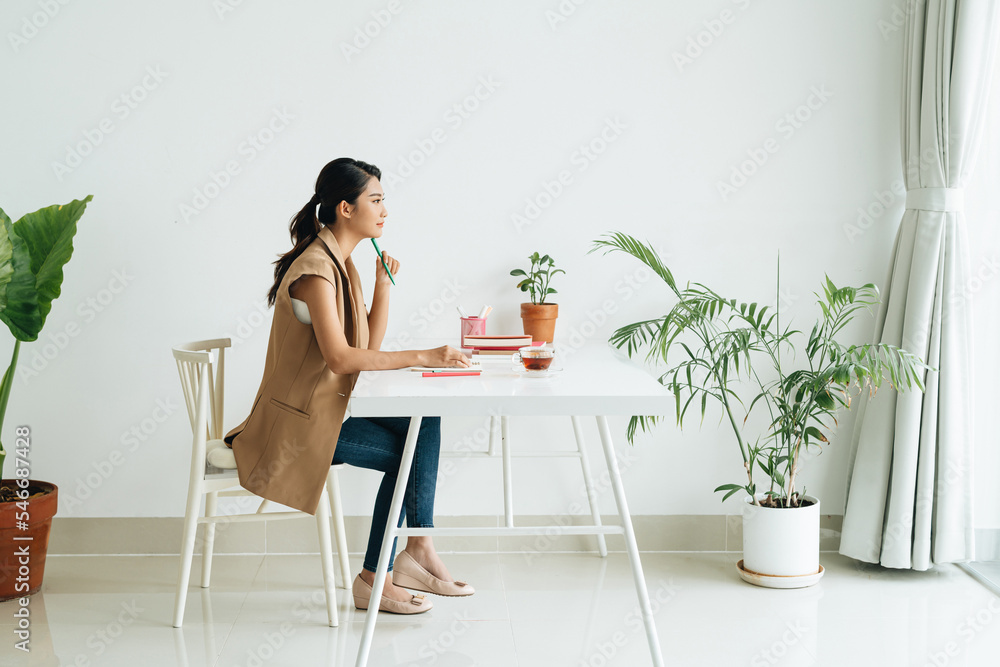 Young female student with book learning at home Young female student with book learning at home