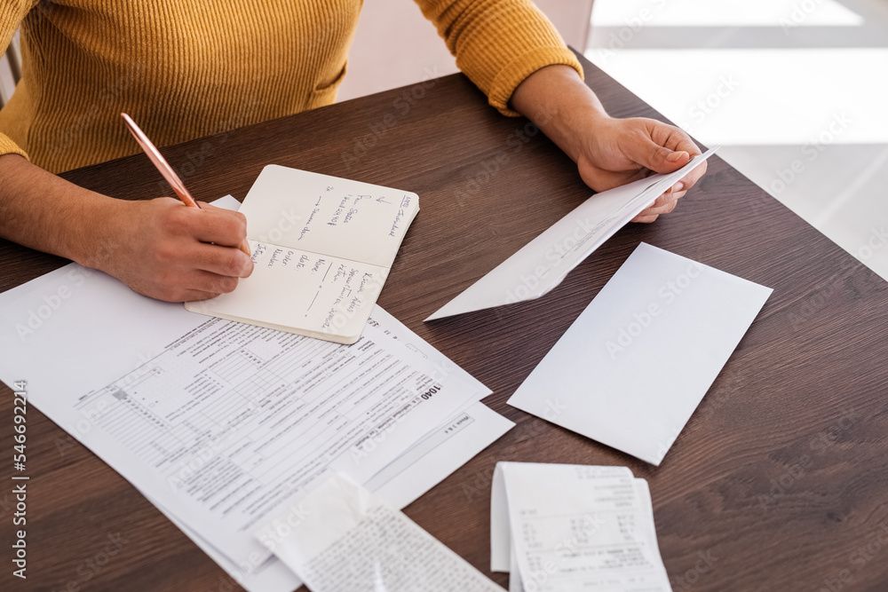 Crop businesswoman making list of letters Crop businesswoman making list of letters
