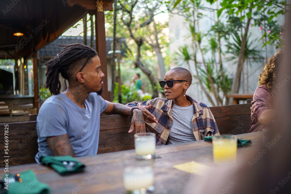 © Jovo Jovanovic/Stocksy - Young man and woman having serious conversation at dinner