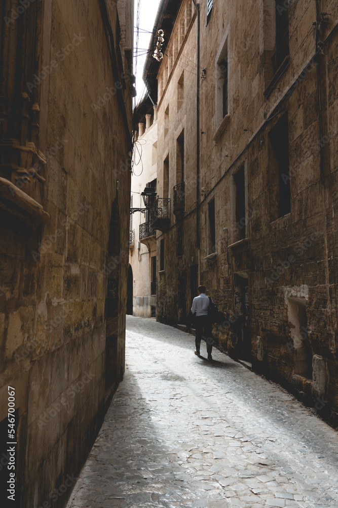 Fototapeta premium Men at a narrow street in a old town