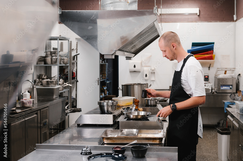 Man working in restaurant kitchen Man working in restaurant kitchen