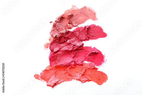 Close up shot of three glossy lipstick heads of different shade without a tube, smudged on white background with a lot of copy space for text.