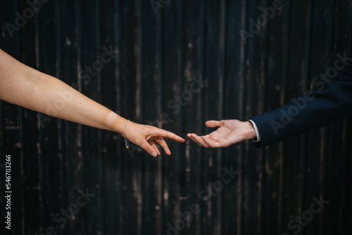 bride and groom softly touching hands photo