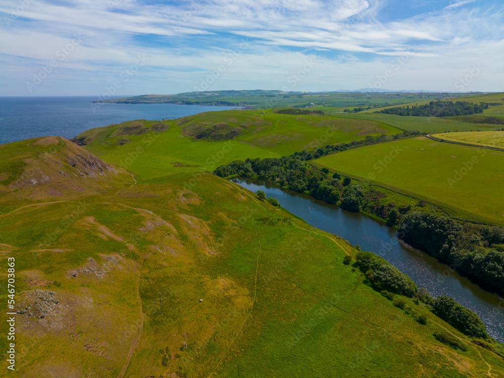 St. Abbs Head coastal cliffs and Mire Loch aerial view in summer near village of St. Abbs, Berwickshire, Scotland, UK. St. Abbs Head coastal cliffs and Mire Loch aerial view in summer near village of St. Abbs, Berwickshire, Scotland, UK.