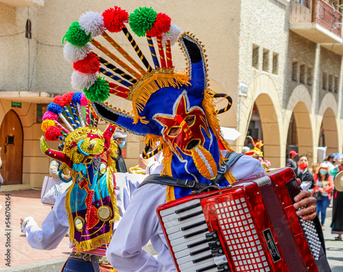 The Christmas parade Pase del Nino (Traveling Child) at historic center of city Cuenca. Participants dressed in costumes of folk character Diablo Huma (Devil). Ecuador