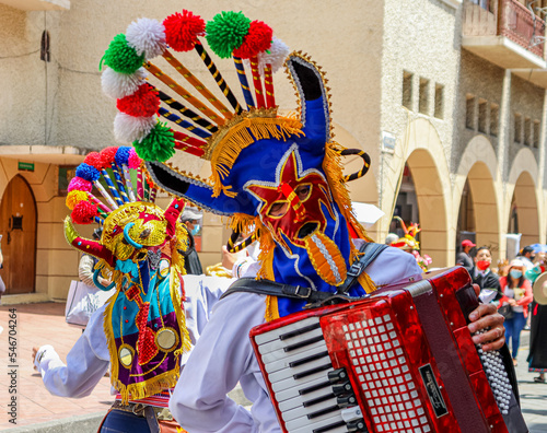 The Christmas parade Pase del Nino (Traveling Child) at historic center of city Cuenca. Participants dressed in costumes of folk character Diablo Huma (Devil). Ecuador photo