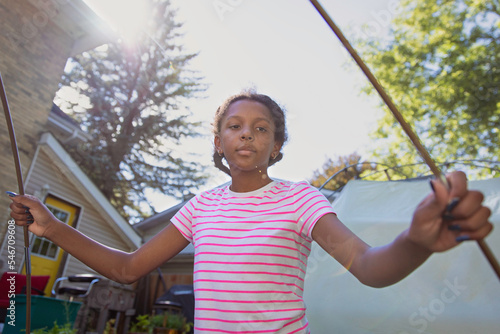Young child helping to assemble a tent