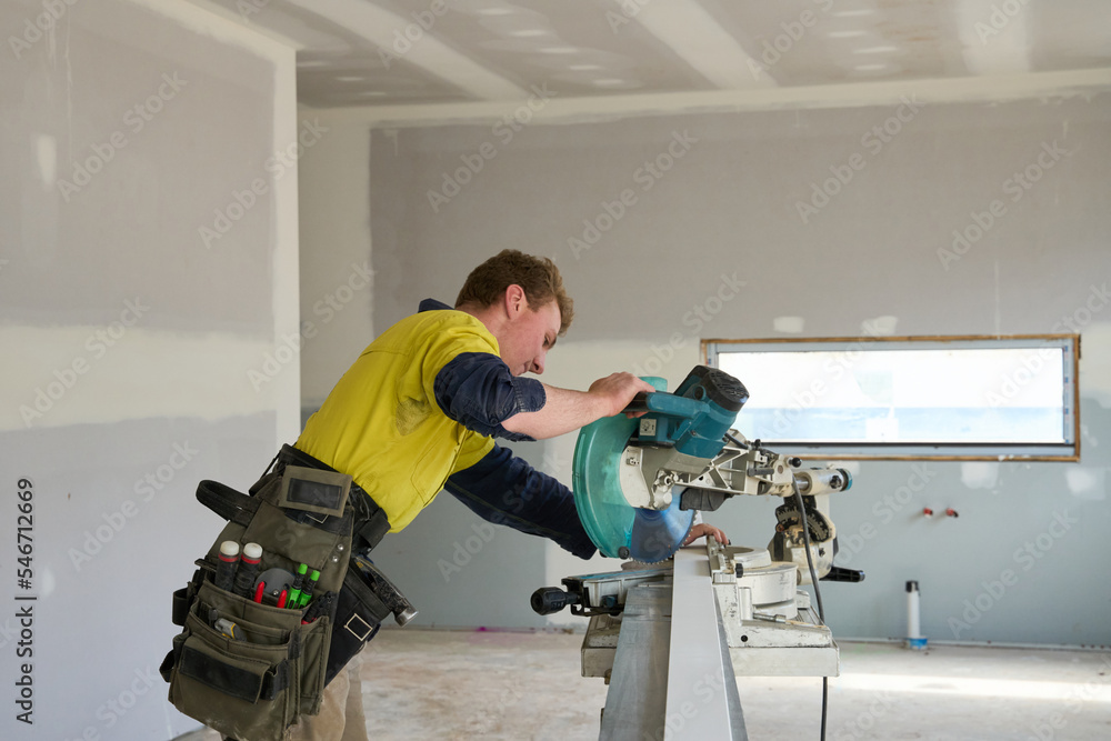Apprentice at work on house build site Apprentice at work on house build site