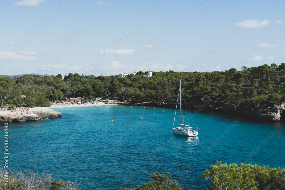 Amazing bay with blue sea and a white sailboat