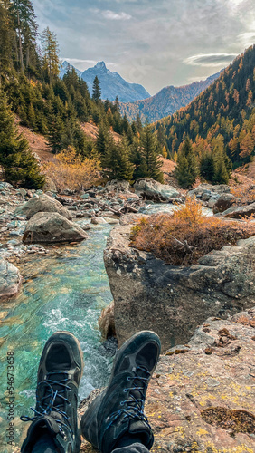 Break at the river, first person shot, first person shot of a river with shoes, view onto a river flowing into the valley, first person view onto a turquoise river with mountainscape,