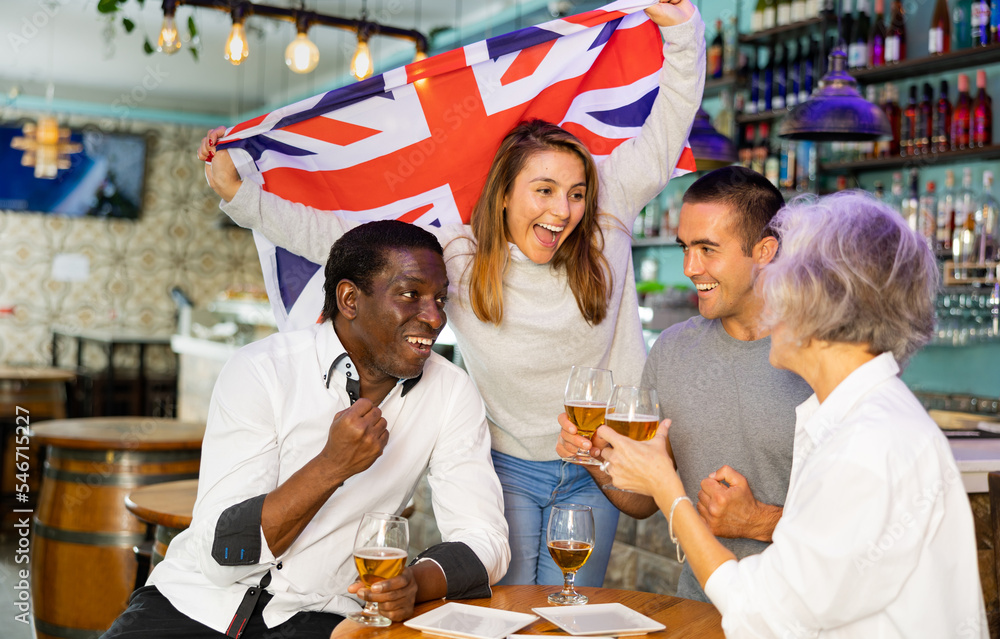 Glad males and females with UK flag clinking glasses with beer on party in  bar Stock Photo | Adobe Stock