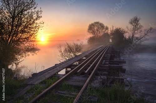 Beautiful summer morning. Bridge with rails at a lovely sunrise.