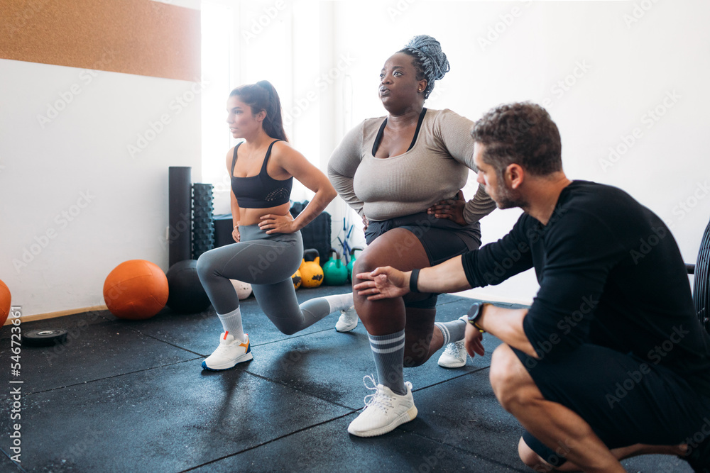 Women Exercising with Personal Trainer Women Exercising with Personal Trainer