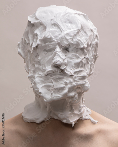 Portrait of a person with their head covered in shaving cream 