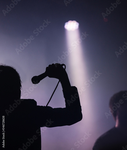 Silhouette of a hard rock band singer photo