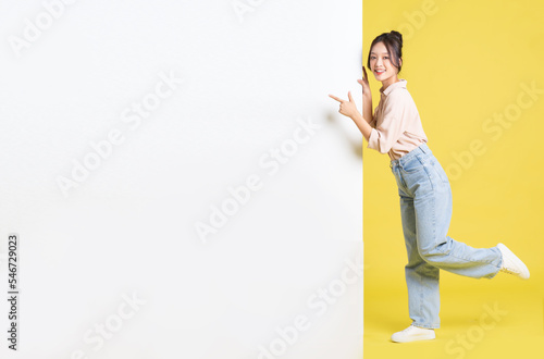 image of Asian girl standing and posing with billboard
