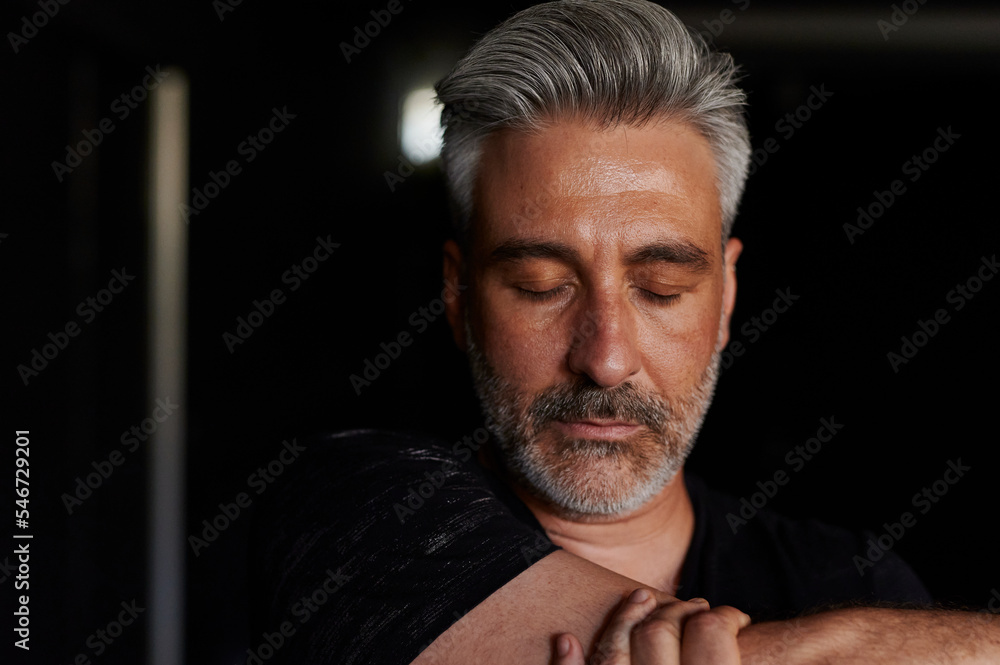 Mature male dancer stretching for rehearsal Mature male dancer stretching for rehearsal