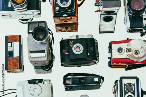Collection of vintage film cameras arranged on a mirror photo