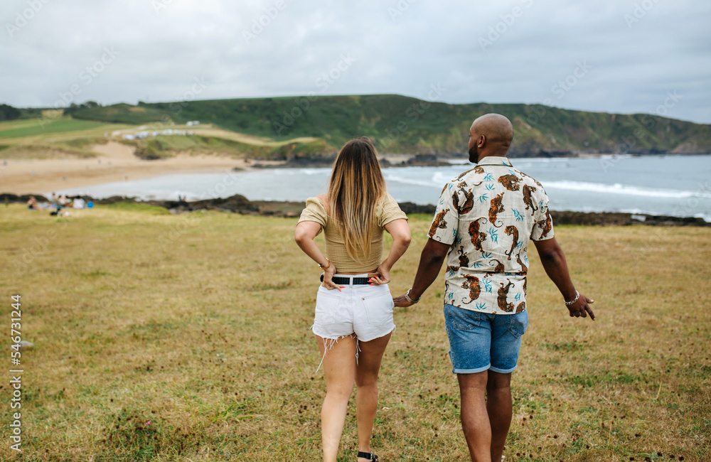 Loving couple holding hands and walking in countryside Loving couple holding hands and walking in countryside