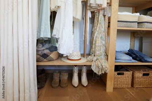 Organized closet with clothes and baskets photo