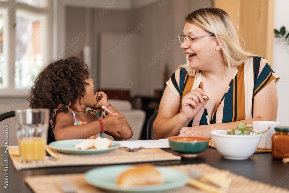 Smiling Mother And Daughter Having Breakfast Together Smiling Mother And Daughter Having Breakfast Together