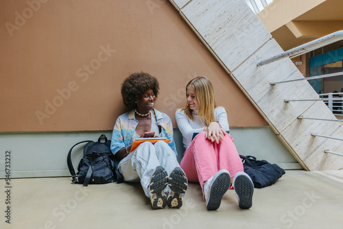 Multiethnic students with textbooks at university campus photo