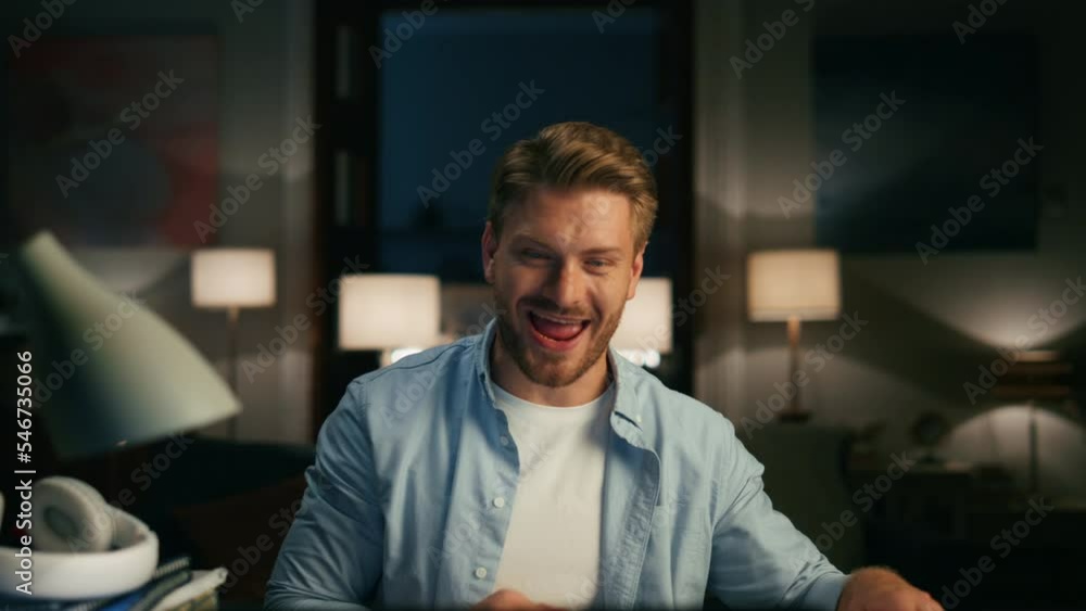 Laughing person watching laptop home webcam view. Man eating sandwich chatting Laughing person watching laptop home webcam view. Man eating sandwich chatting