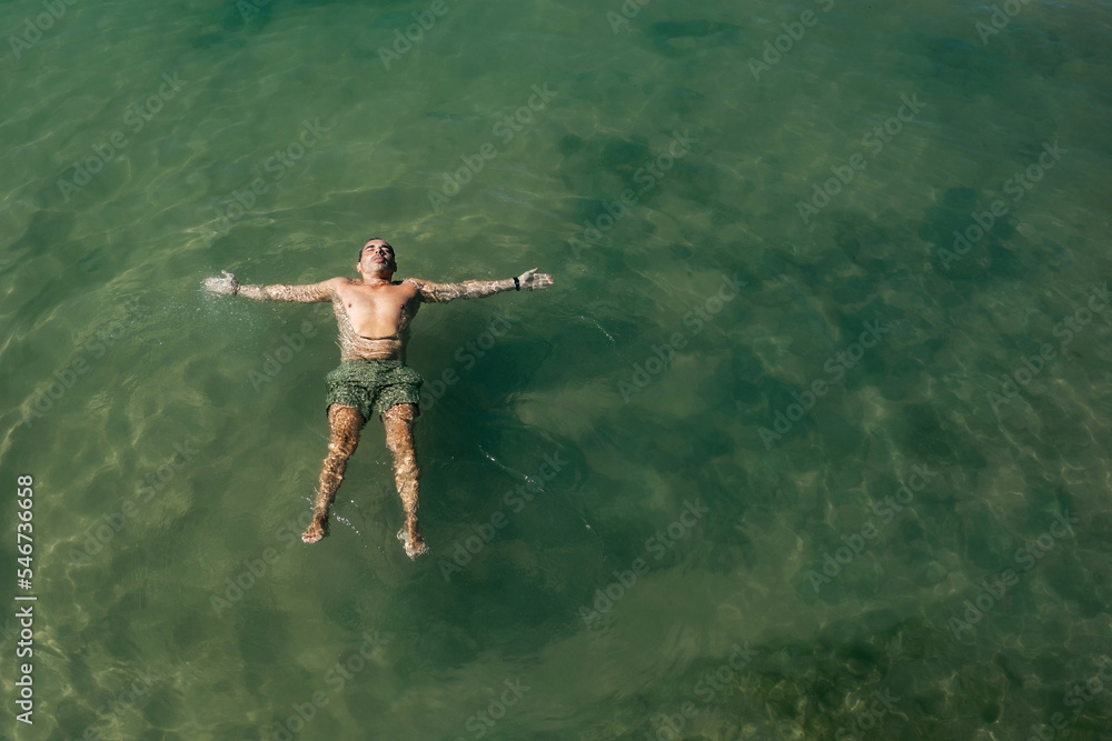 man bathing lying on his back in the sea man bathing lying on his back in the sea