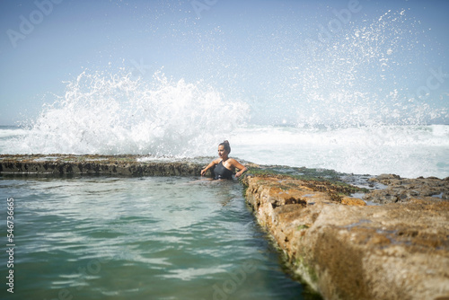 woman inside a natural pool by the sea