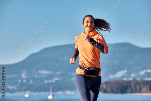 Fototapeta Naklejka Na Ścianę i Meble -  Happy female runner jogging in nature.